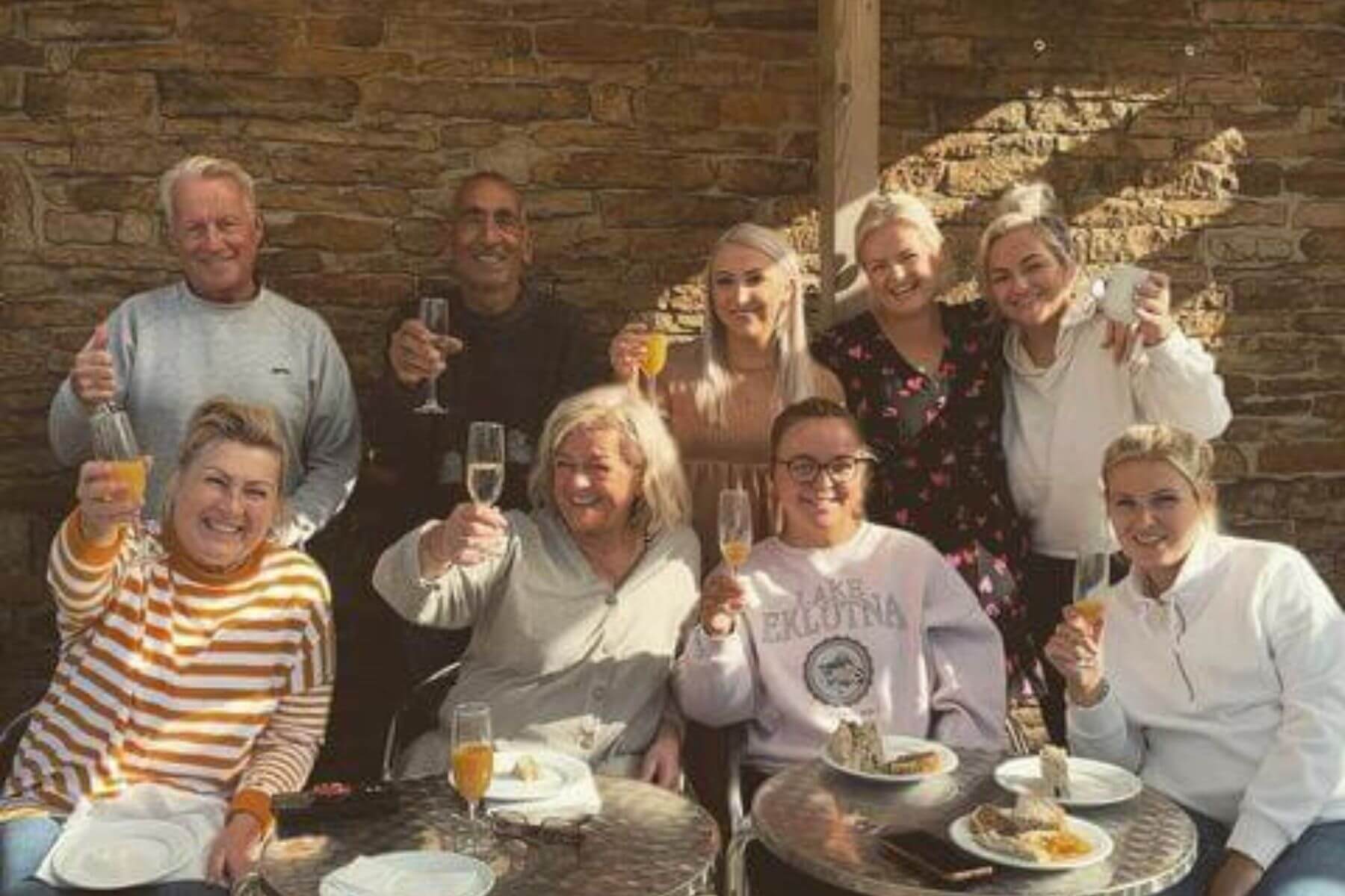 group of people holding up glasses