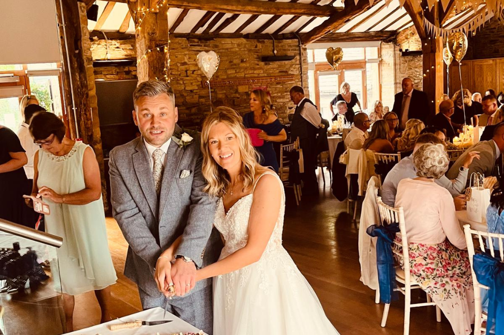 Bride and groom cutting cake at The Northorpe Barn
